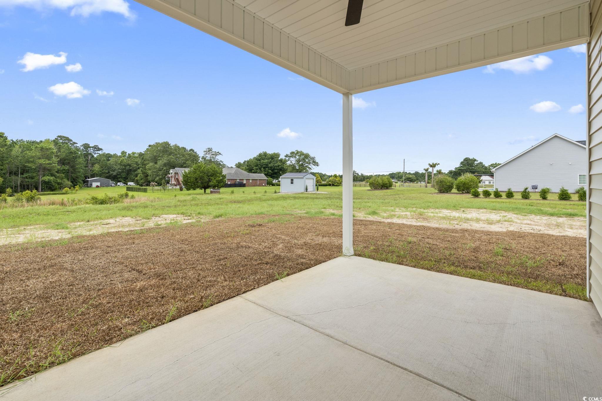 108 Infinity Lane Loris, SC 29569 - Photo 28 of 35 View of patio featuring ceiling fan and an outbuil