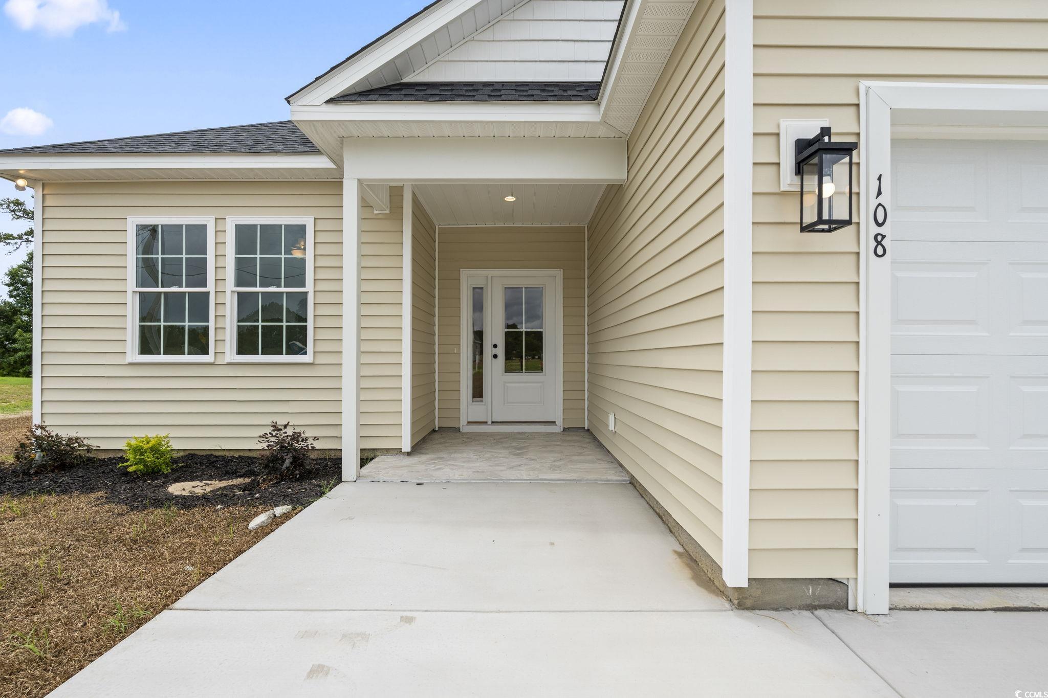108 Infinity Lane Loris, SC 29569 - Photo 3 of 35 View of exterior entry featuring a shingled roof a