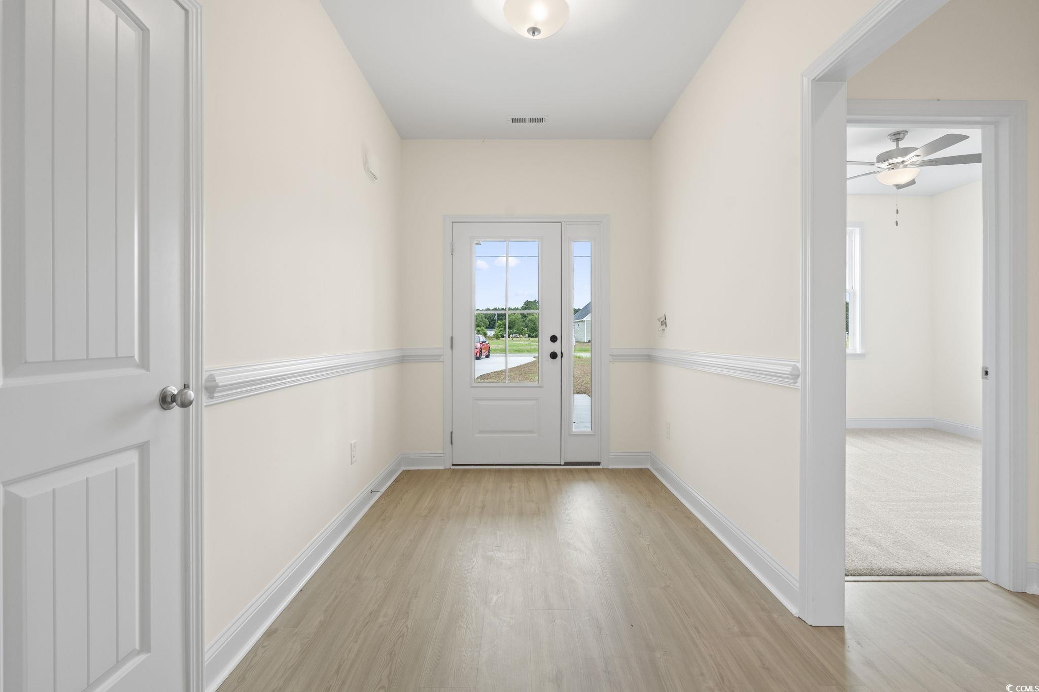 108 Infinity Lane Loris, SC 29569 - Photo 4 of 35 Doorway to outside featuring wood finished floors