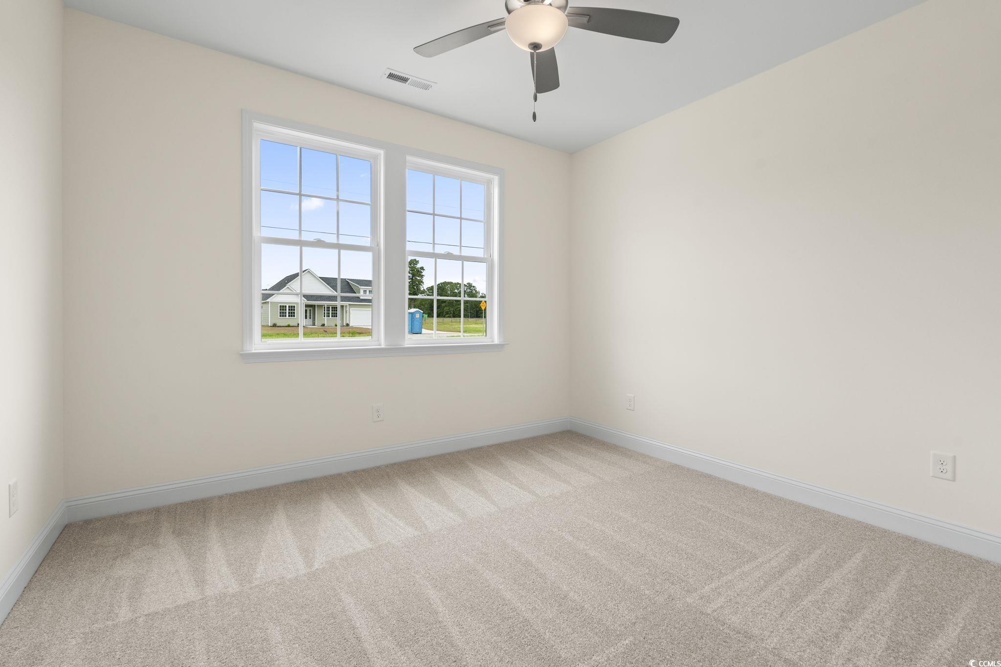 108 Infinity Lane Loris, SC 29569 - Photo 6 of 35 Guest bedroom with light colored carpet and ceilin