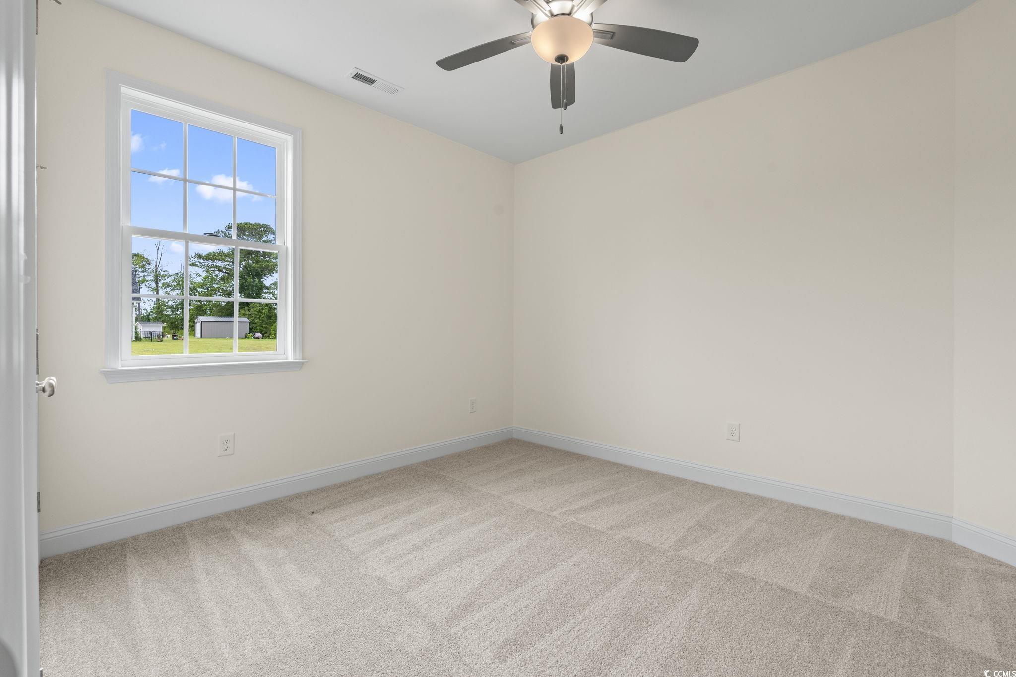 108 Infinity Lane Loris, SC 29569 - Photo 8 of 35 Guest bedroom featuring light carpet and a ceiling