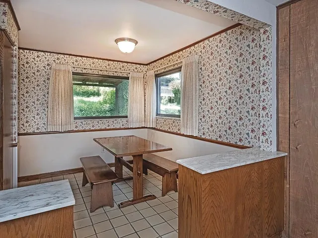 a view of a dining table and chairs in a room