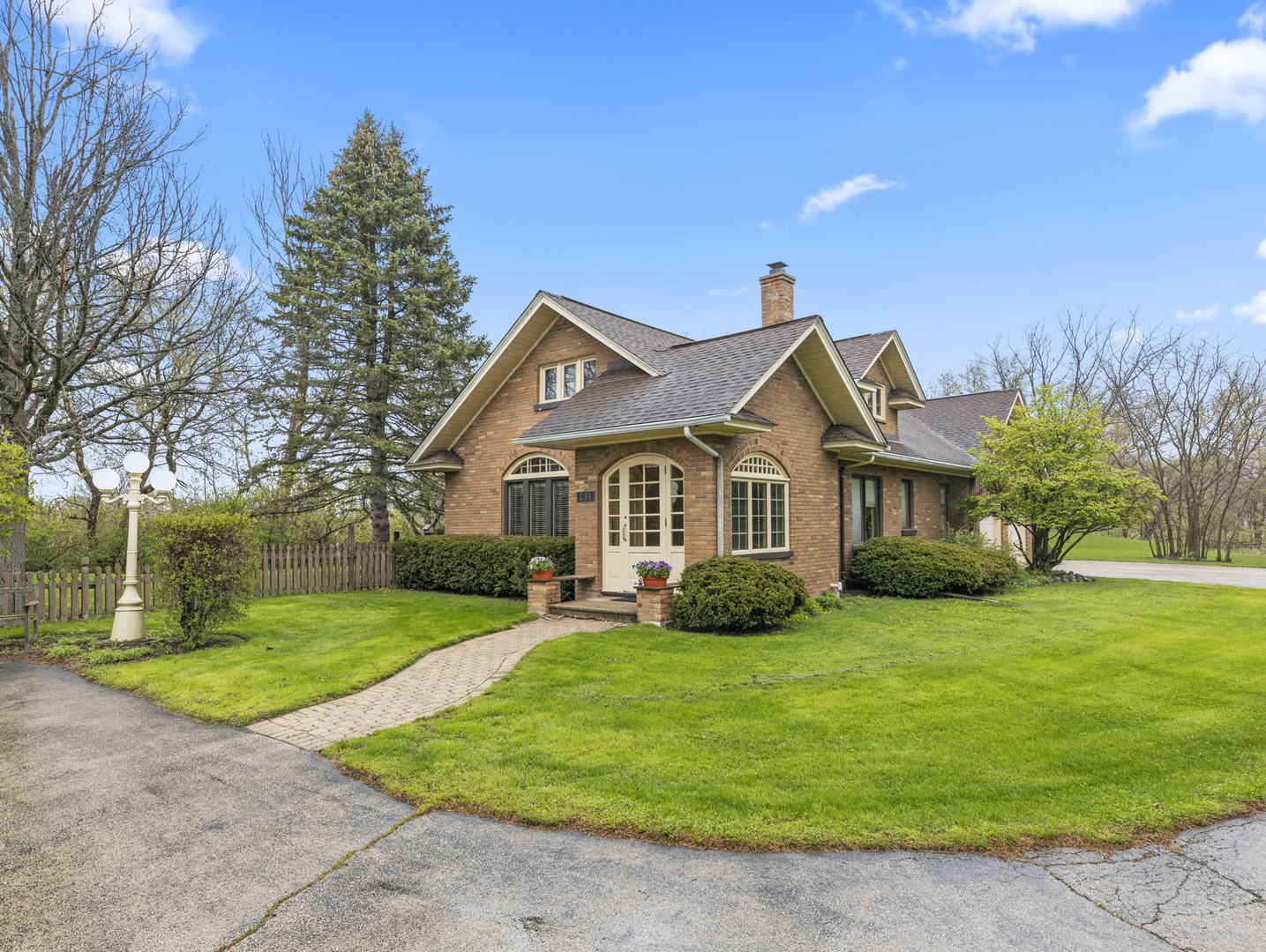 231 Bethany Road Sycamore, IL 60178 - Photo 7 of 37 a front view of a house with a yard and garage