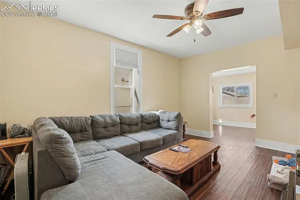 a living room with furniture and a wooden floor