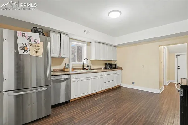 a kitchen with stainless steel appliances a refrigerator sink and cabinets