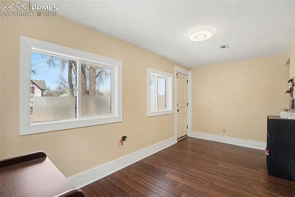 a view of room with window and wooden floor