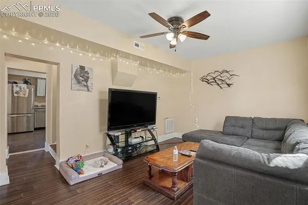 a living room with furniture and a flat screen tv