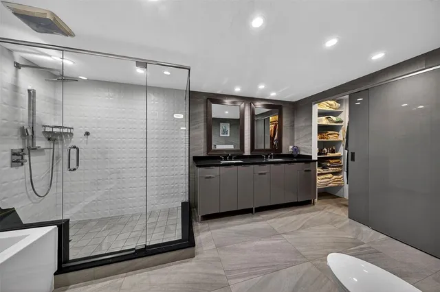 a large bathroom with a double vanity sink and a mirror