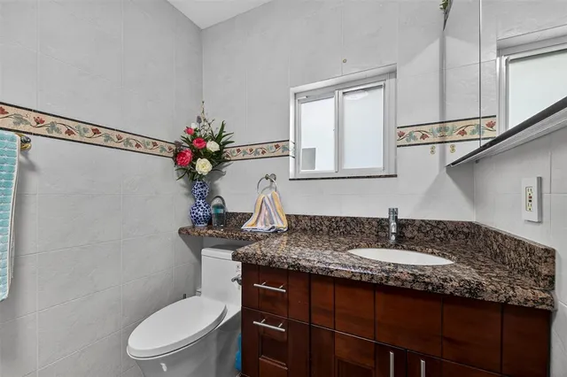a bathroom with a toilet sink and mirror