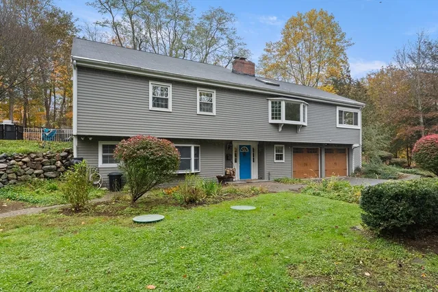a kitchen with stainless steel appliances granite countertop a table chairs in it and wooden floors