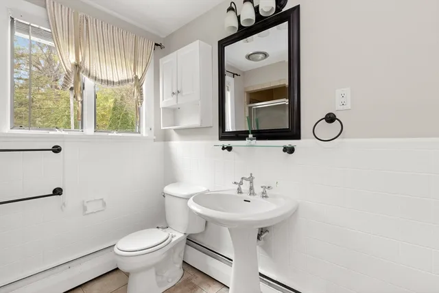 a bathroom with a granite countertop sink and mirror