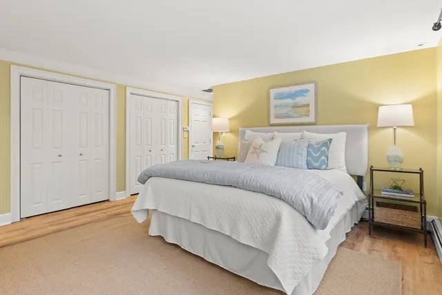 a bathroom with a granite countertop sink a mirror a bathtub and shower