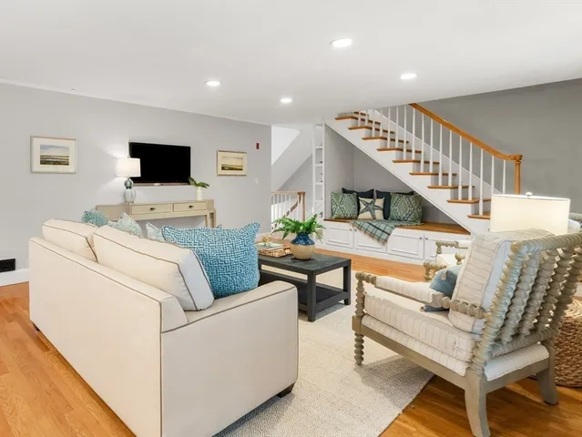 a living room with furniture a large window and a flat screen tv