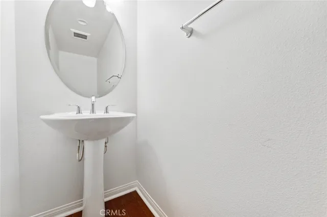 a bathroom with a sink a mirror and a window