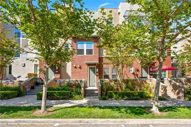 front view of a house with a tree