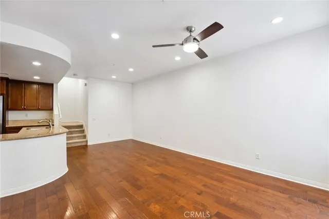 a view of a kitchen with a sink and a refrigerator