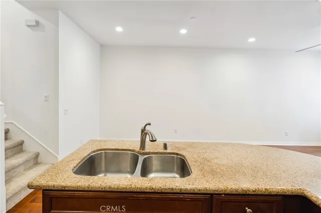 a kitchen with granite countertop a sink and cabinets