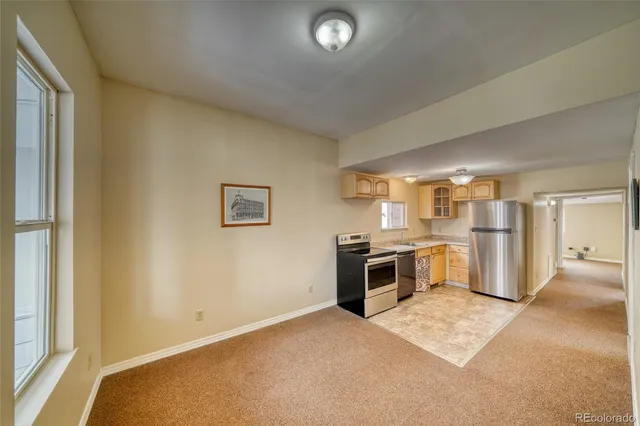 a kitchen with a refrigerator and a stove top oven