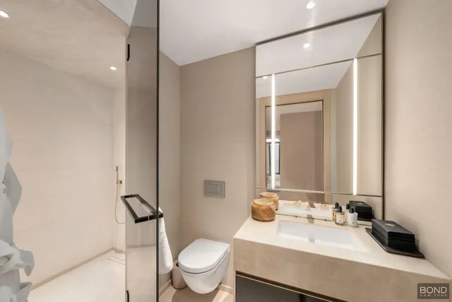 a bathroom with a tub sink and mirror