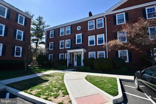 a front view of a residential apartment building with a yard