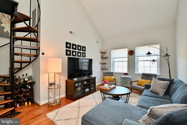 a livingroom with wooden floor and furniture
