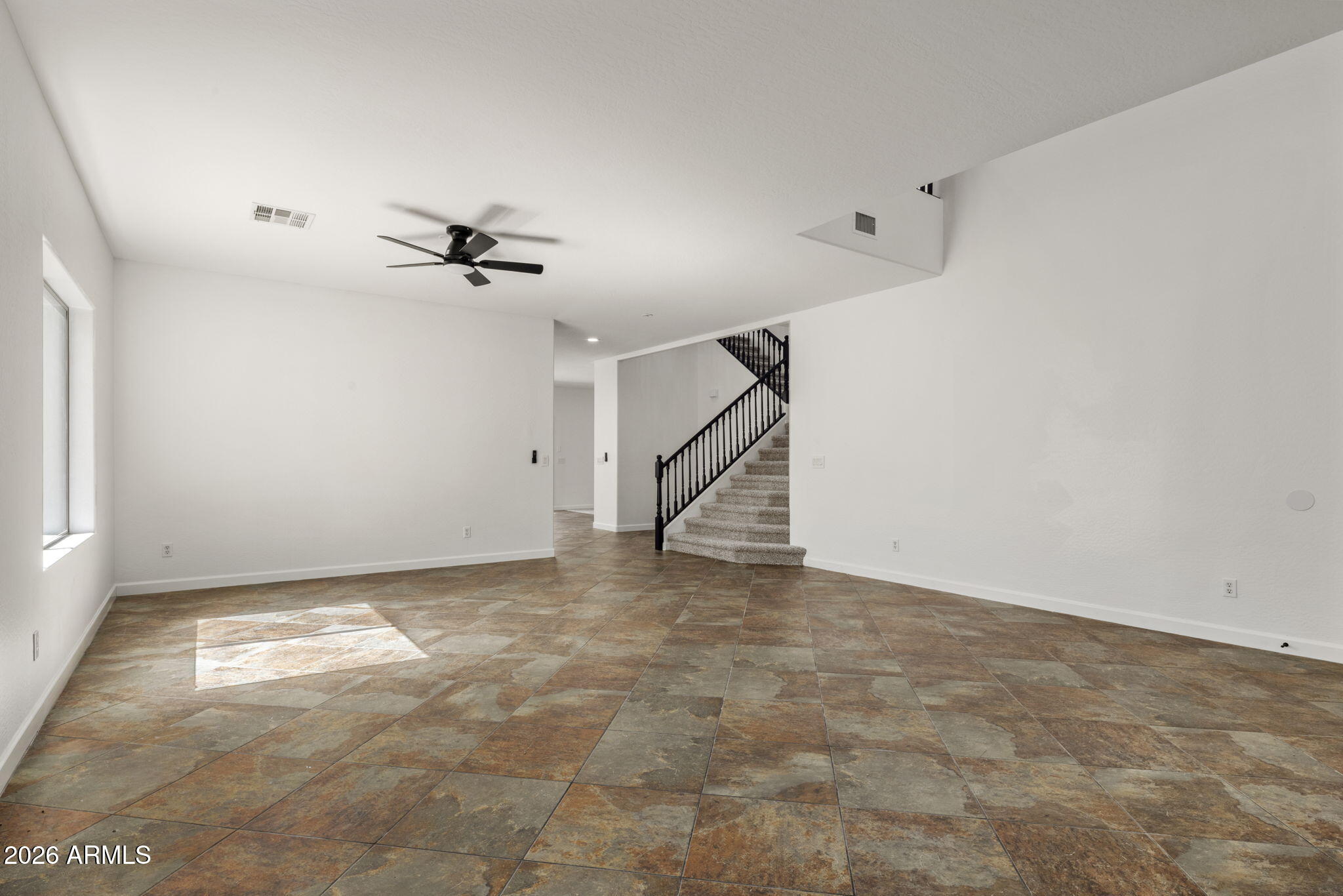5121 West Beverly Road Laveen, AZ 85339 - Photo 12 of 32 a view of an empty room with a ceiling fan