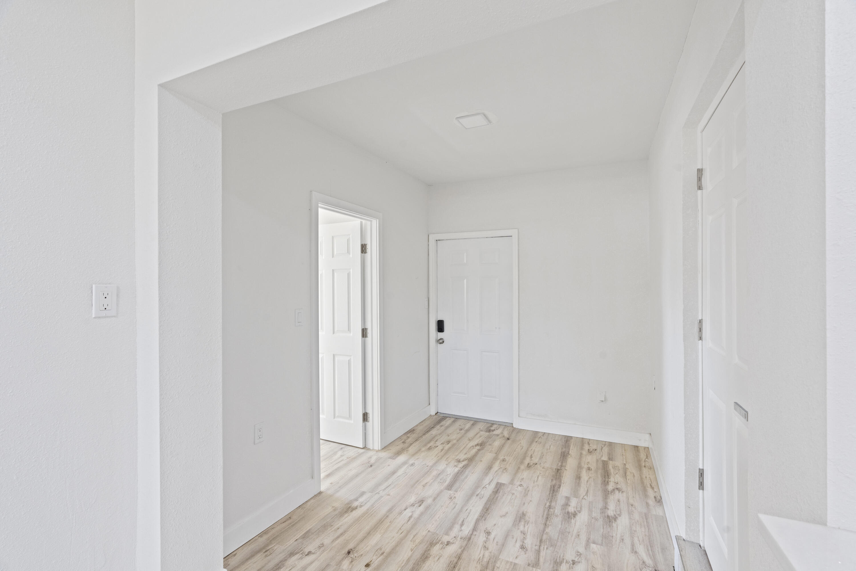 662 Granada Street Fort Pierce, FL 34949 - Photo 14 of 48 a view of a room with wooden floor and a hallway