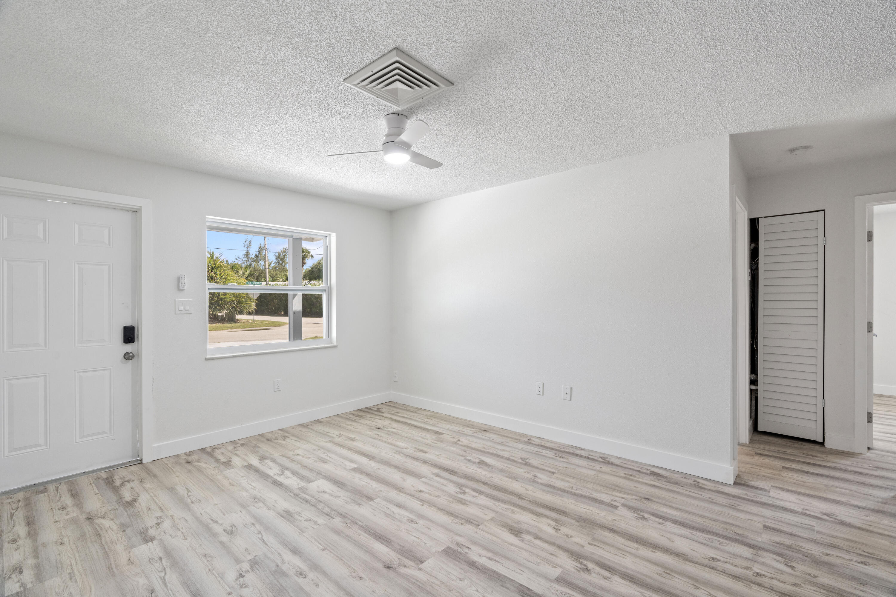 662 Granada Street Fort Pierce, FL 34949 - Photo 15 of 48 wooden floor in an empty room with a window