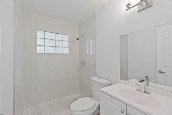 a bathroom with a sink toilet and shower