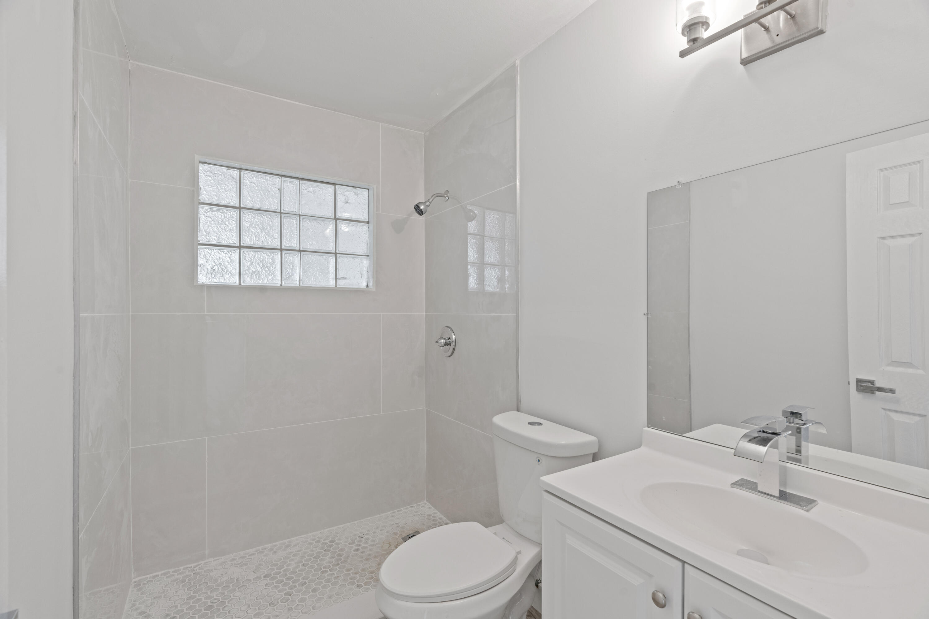 662 Granada Street Fort Pierce, FL 34949 - Photo 19 of 48 a bathroom with a sink toilet and shower
