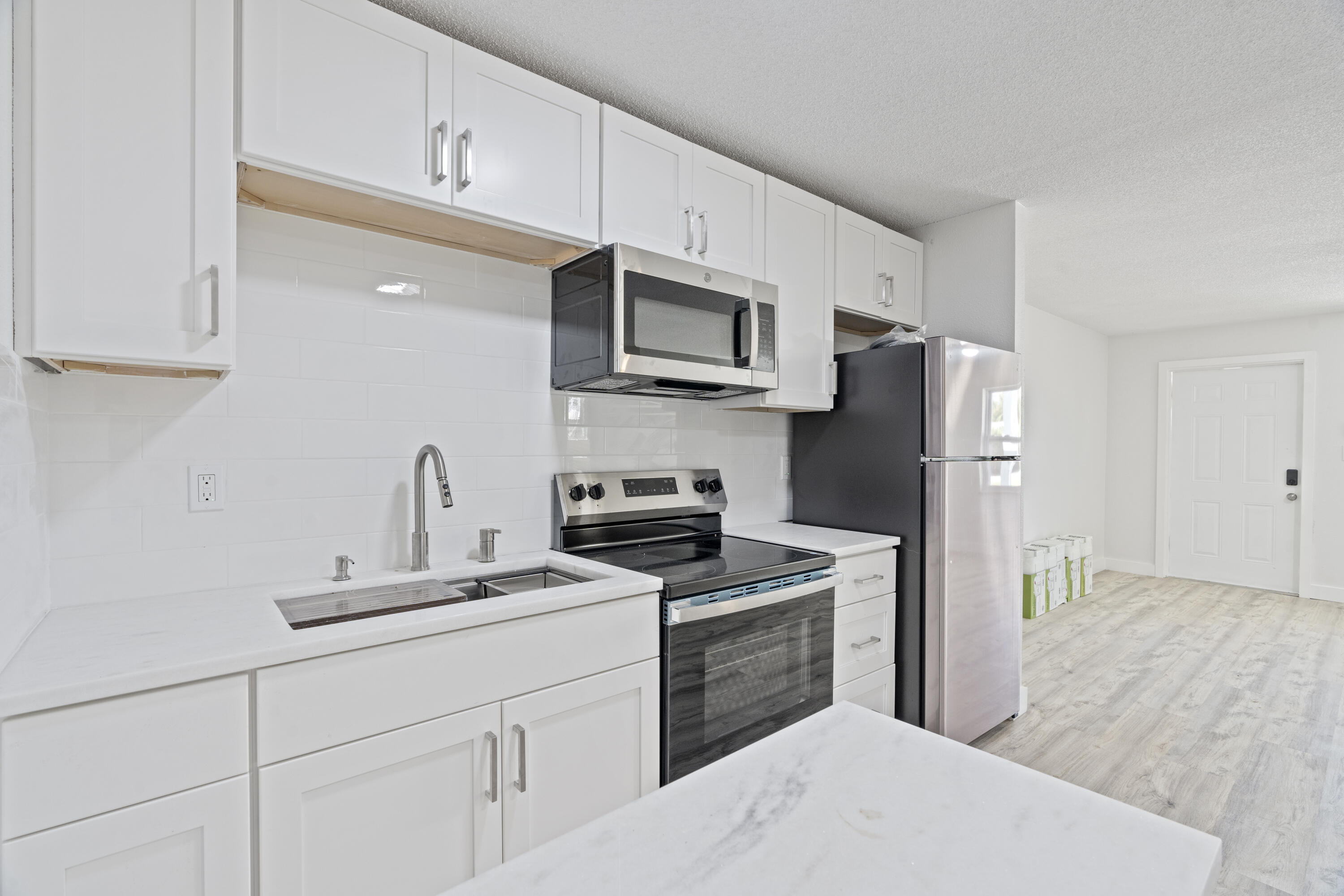 662 Granada Street Fort Pierce, FL 34949 - Photo 24 of 48 a kitchen with stainless steel appliances a refrigerator sink and microwave