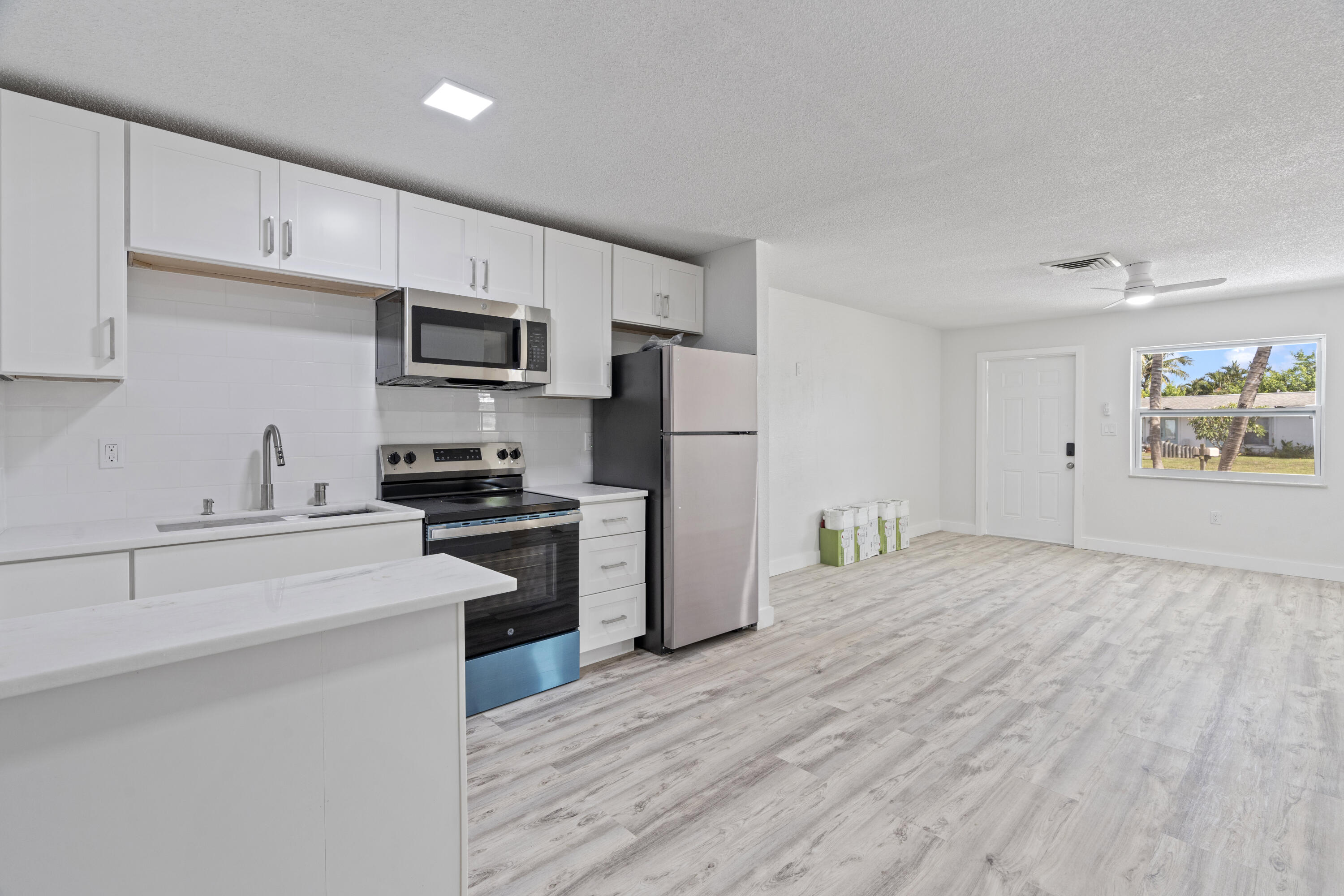 662 Granada Street Fort Pierce, FL 34949 - Photo 25 of 48 a kitchen with a refrigerator cabinets and wooden floor