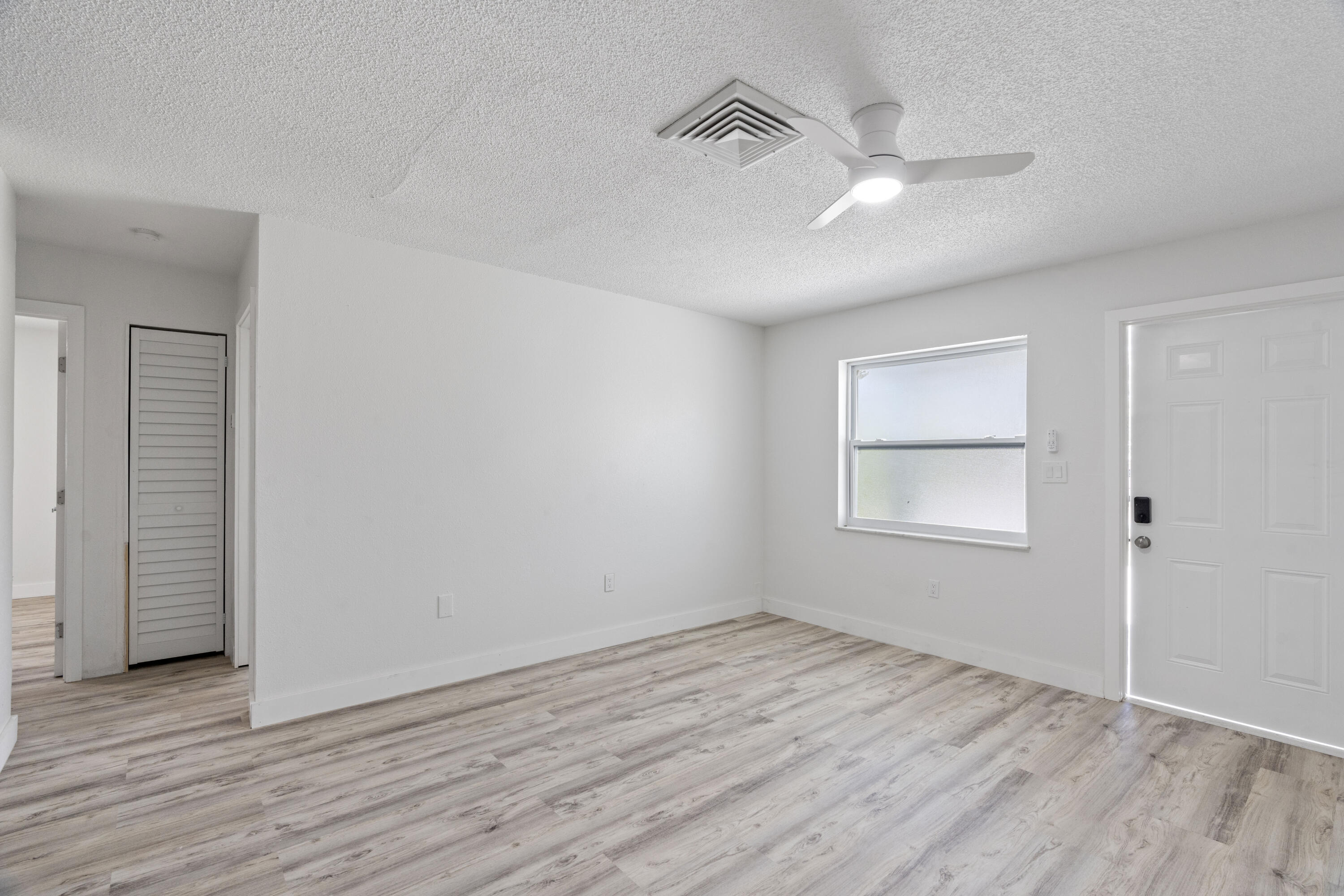 662 Granada Street Fort Pierce, FL 34949 - Photo 26 of 48 wooden floor in an empty room with a window