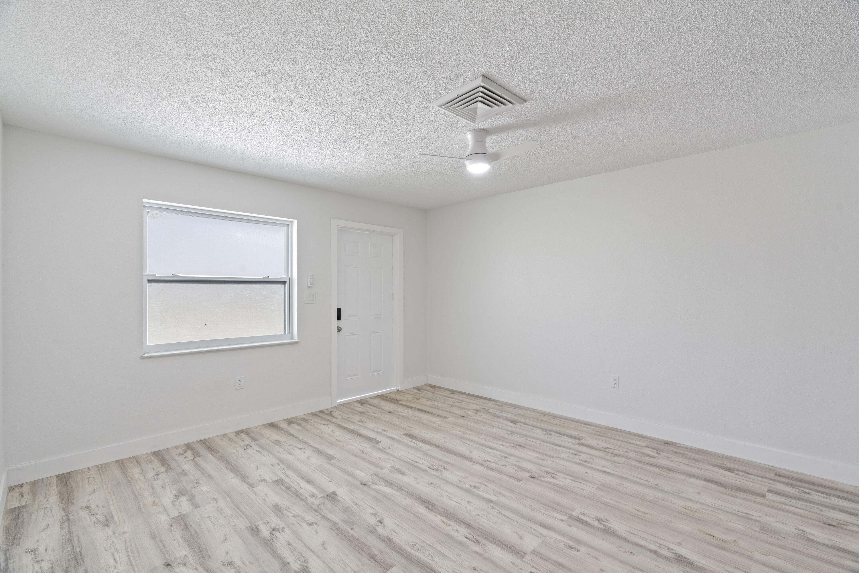 662 Granada Street Fort Pierce, FL 34949 - Photo 28 of 48 wooden floor in an empty room with a window
