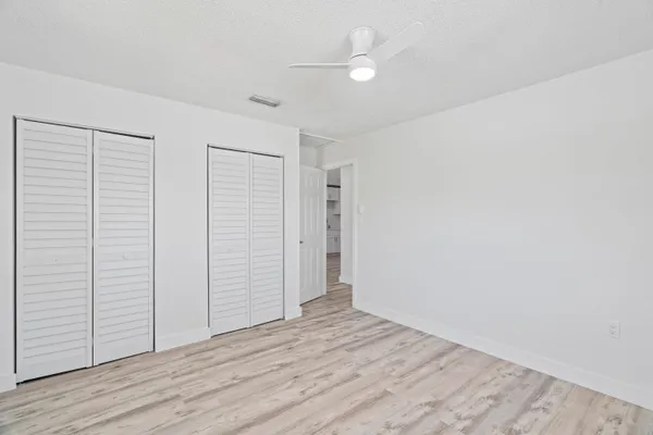 an empty room with wooden floor and closet