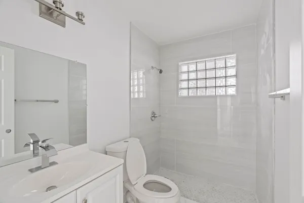 a bathroom with a sink toilet and shower