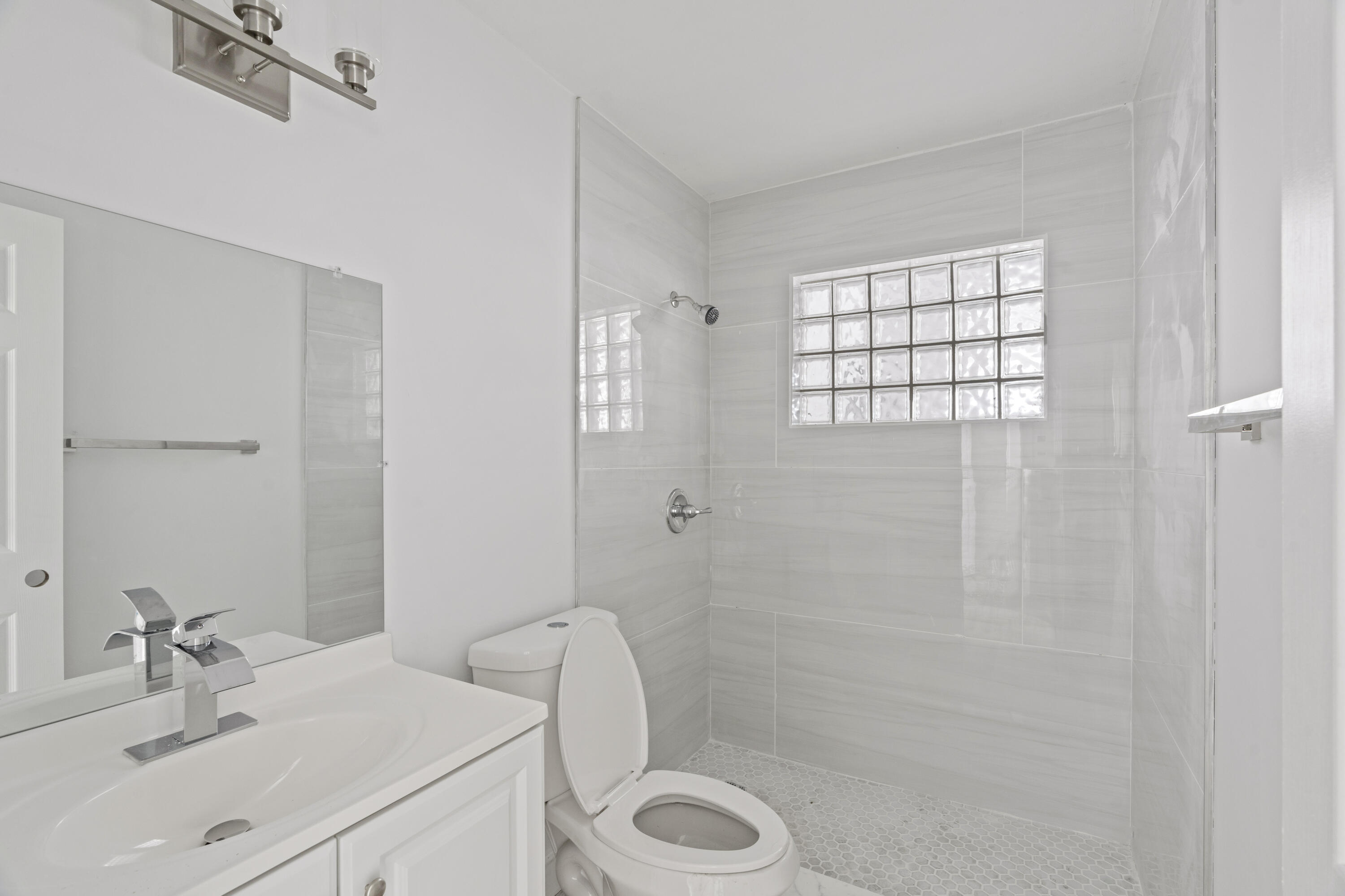 662 Granada Street Fort Pierce, FL 34949 - Photo 33 of 48 a bathroom with a sink toilet and shower