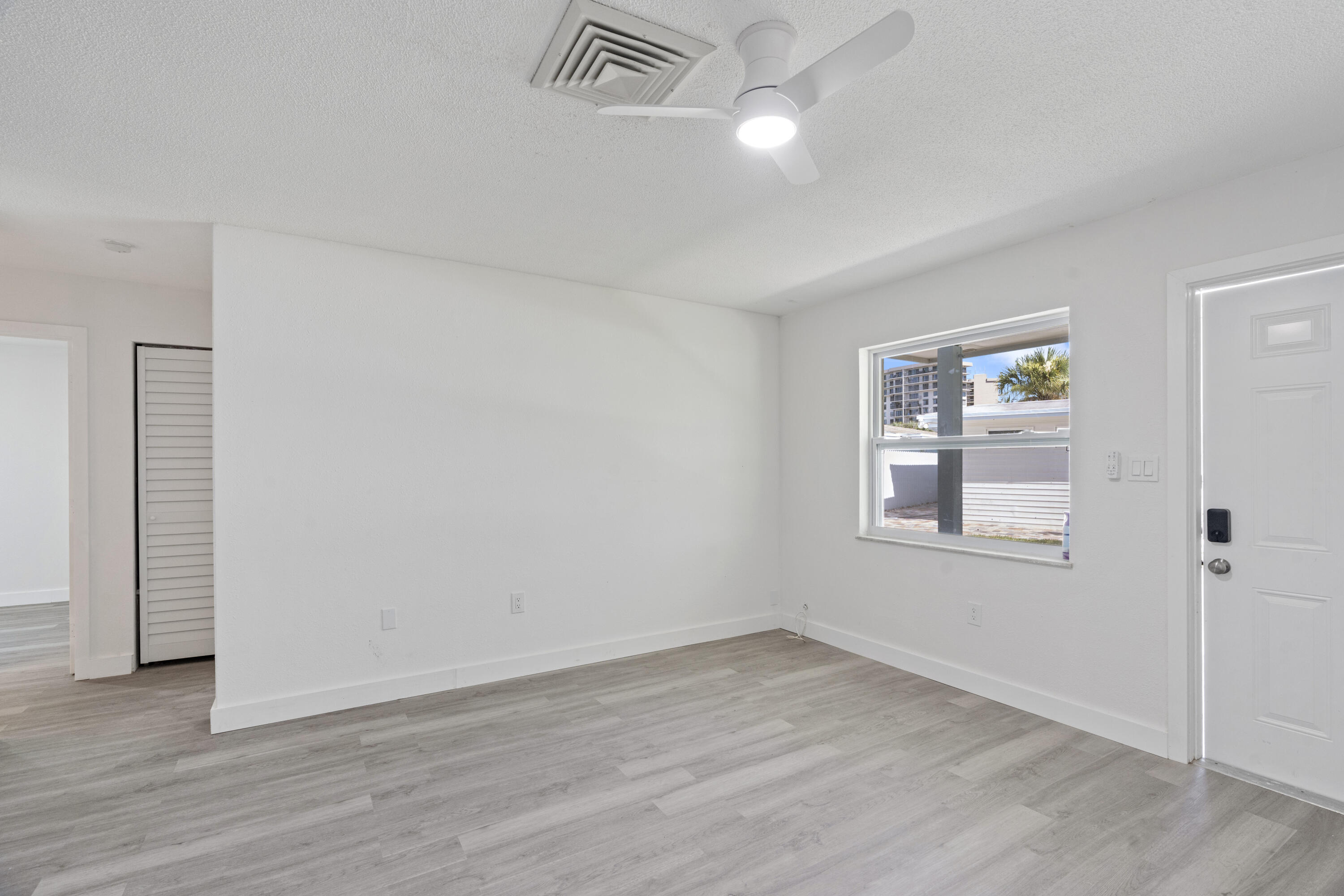662 Granada Street Fort Pierce, FL 34949 - Photo 37 of 48 an empty room with wooden floor and windows
