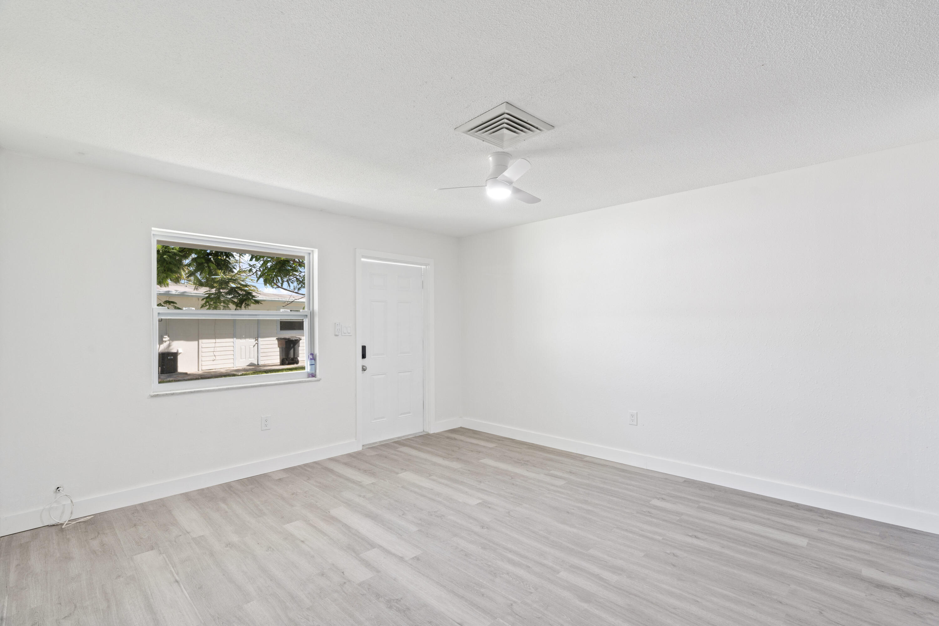 662 Granada Street Fort Pierce, FL 34949 - Photo 39 of 48 wooden floor in an empty room with a window