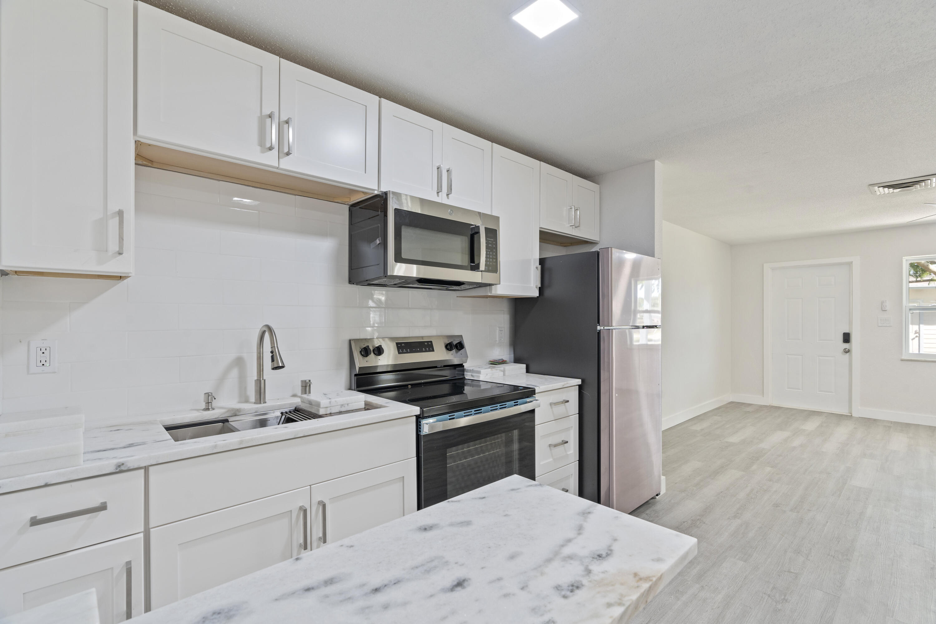 662 Granada Street Fort Pierce, FL 34949 - Photo 45 of 48 a kitchen with a refrigerator stove and sink