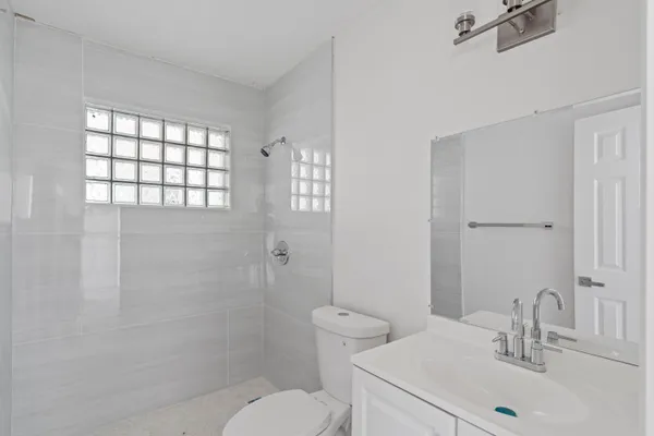a bathroom with a sink toilet and shower