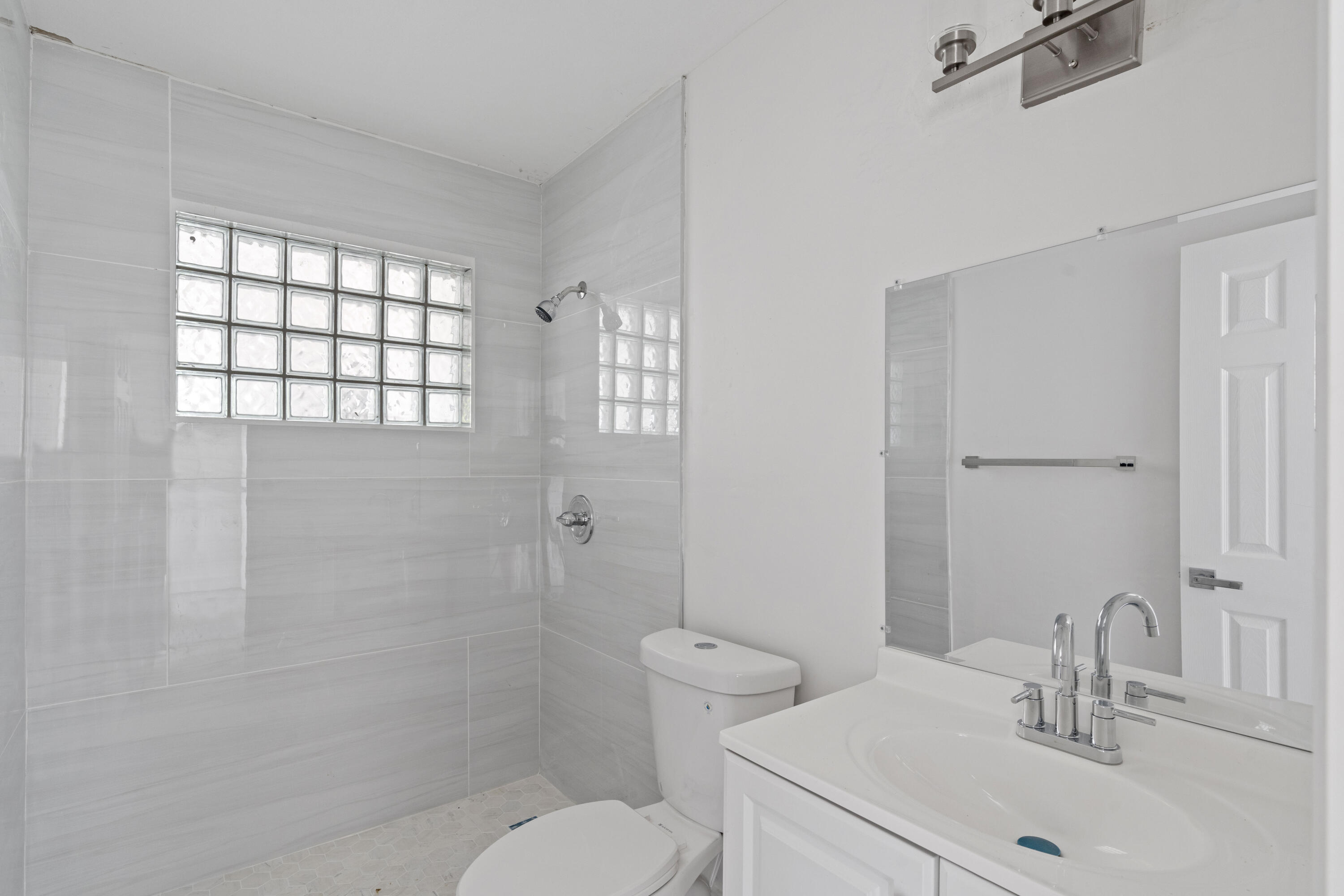 662 Granada Street Fort Pierce, FL 34949 - Photo 47 of 48 a bathroom with a sink toilet and shower