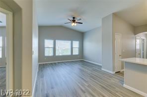 8777 Roping Rodeo Avenue, Unit 101 Las Vegas, NV 89178 - Photo 4 of 8 Natural light floods this living area, highlighting the vaulted ceiling and resilient flooring.