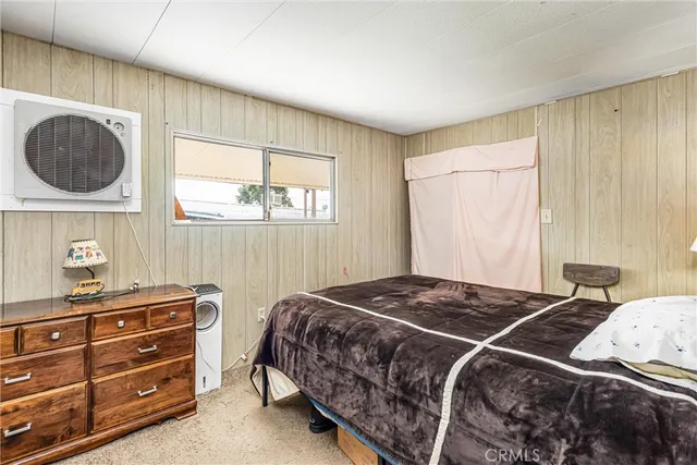 a bedroom with a bed and lamp