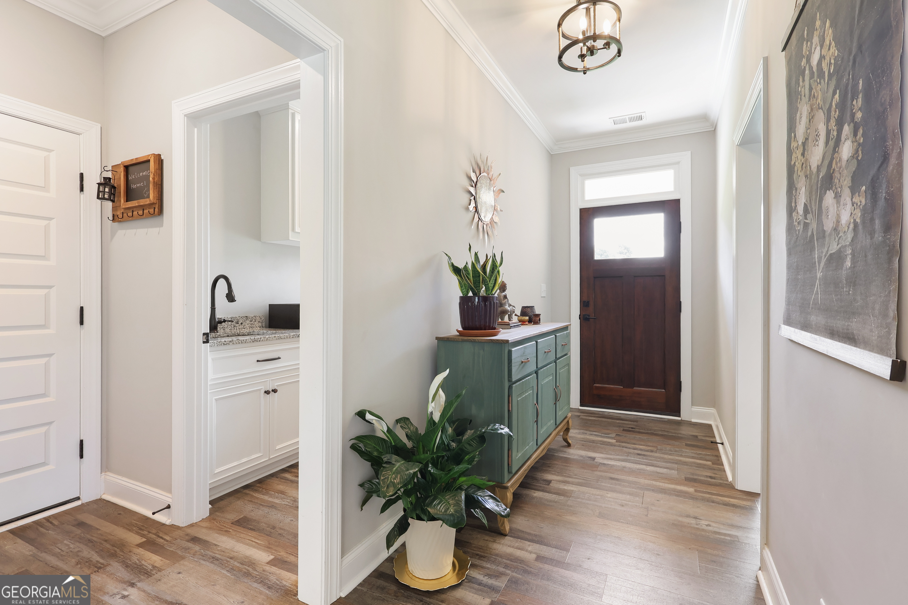 89 Claire Road Forsyth, GA 31029 - Photo 7 of 40 a hallway with sink and wooden floor