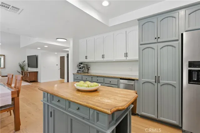 a kitchen with sink cabinets and refrigerator