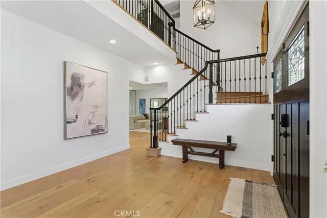 a view of staircase with wooden floor and a rug