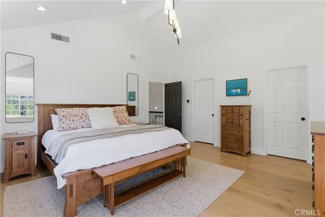 a spacious bedroom with a bed and a walk in closet