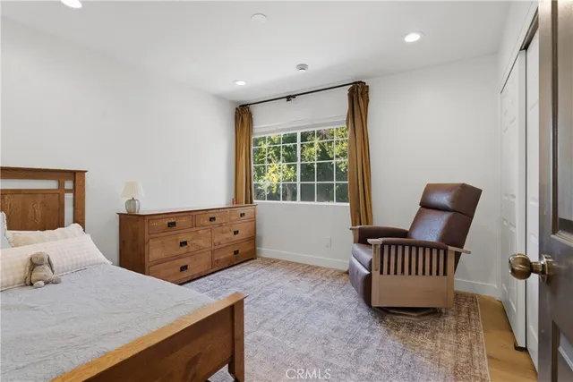 a bedroom with furniture and a window