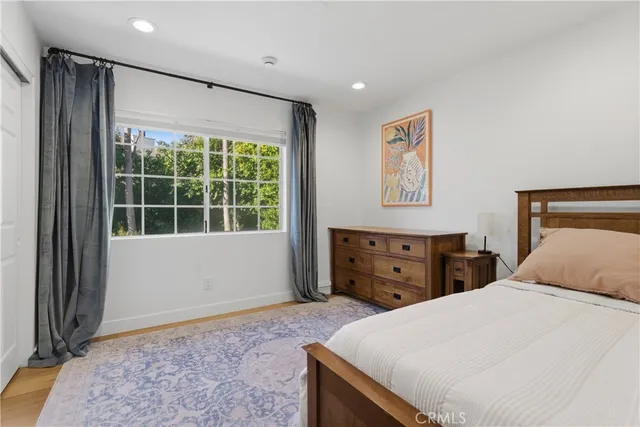 a bedroom with a large bed and a window